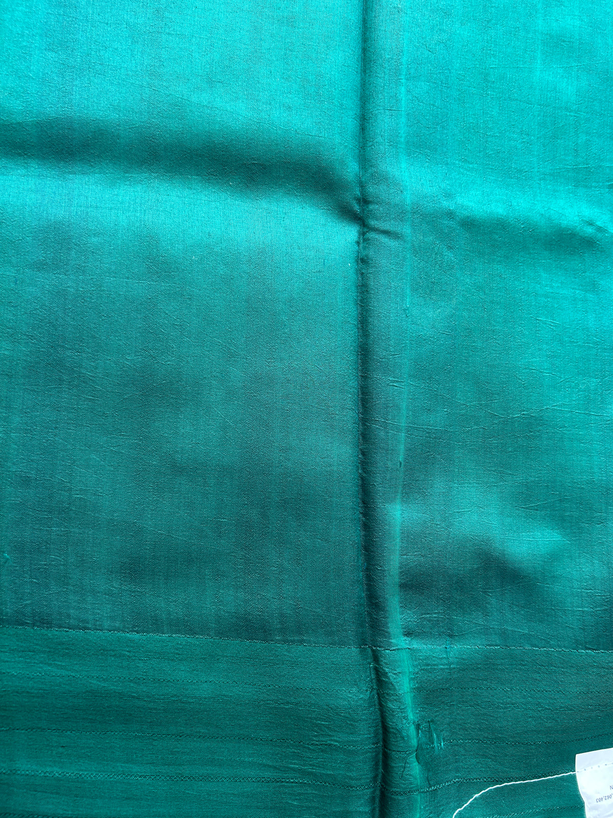 Pure Chiniya Silk Saree Bottle Green Colored Elegantly Paired with a Gold Zari Border.