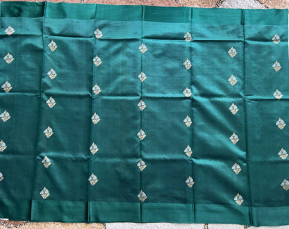 Pure Chiniya Silk Saree Bottle Green Colored Elegantly Paired with a Gold Zari Border.