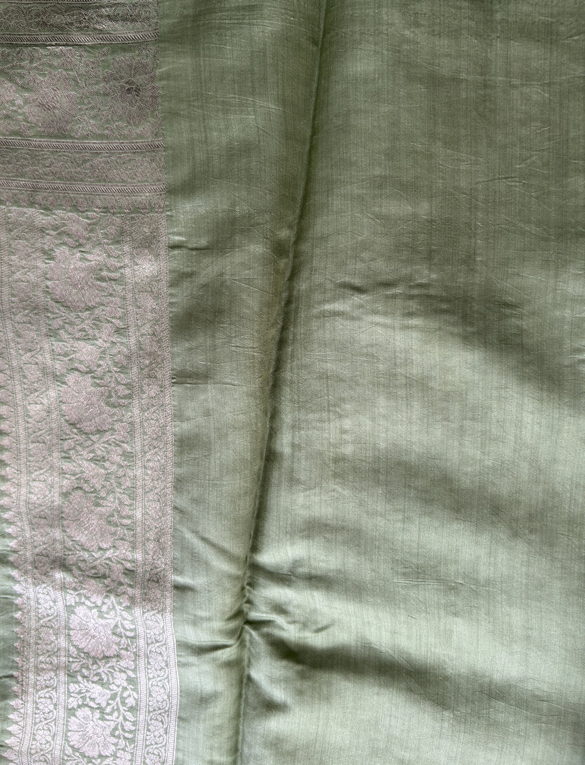 Pure Chiniya Silk Saree Mint Light Green Colored Elegantly Paired with a Gold Zari Border.