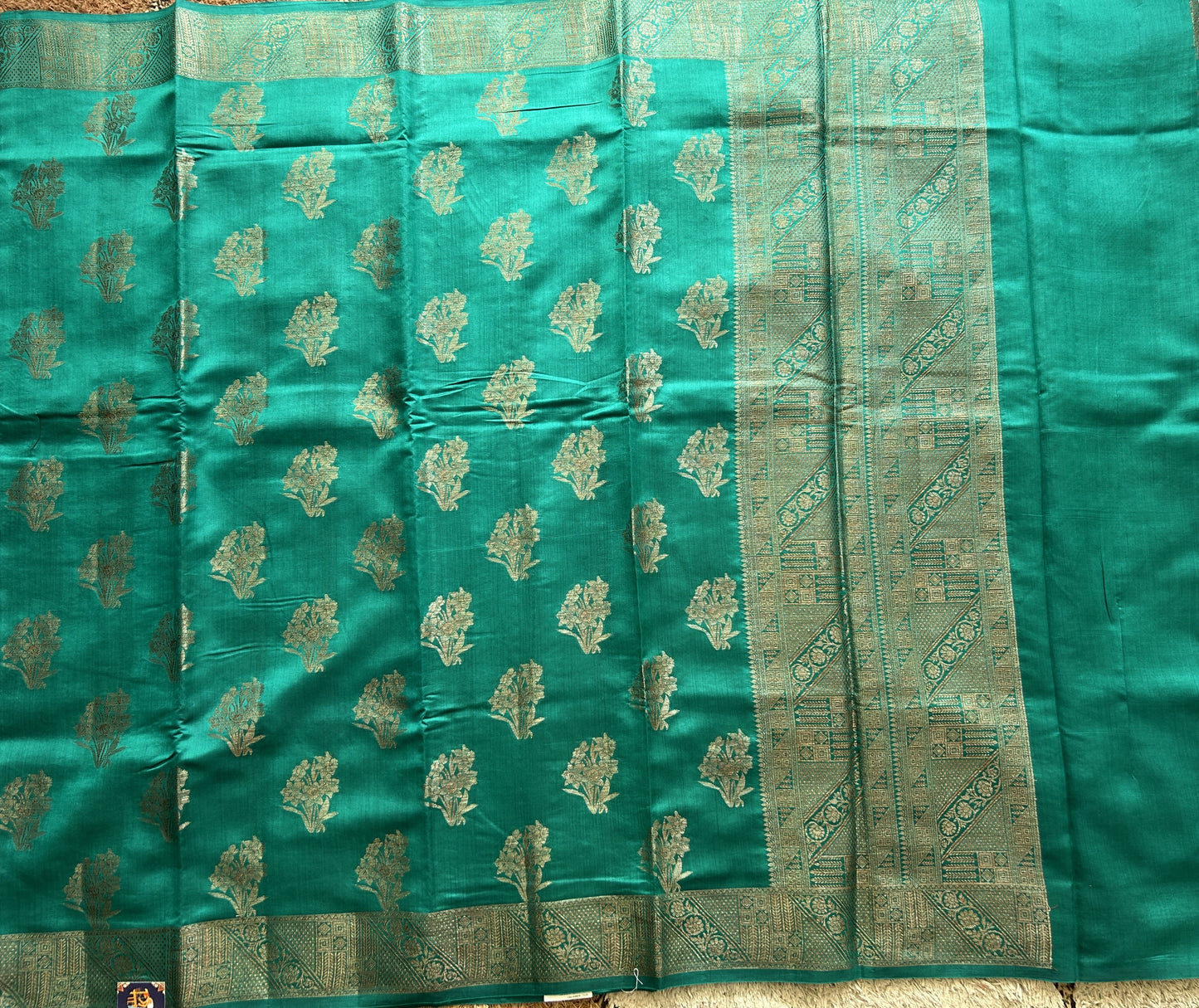 Pure Chiniya Silk Saree Rama Green Colored Elegantly Paired with a Gold Zari Border.