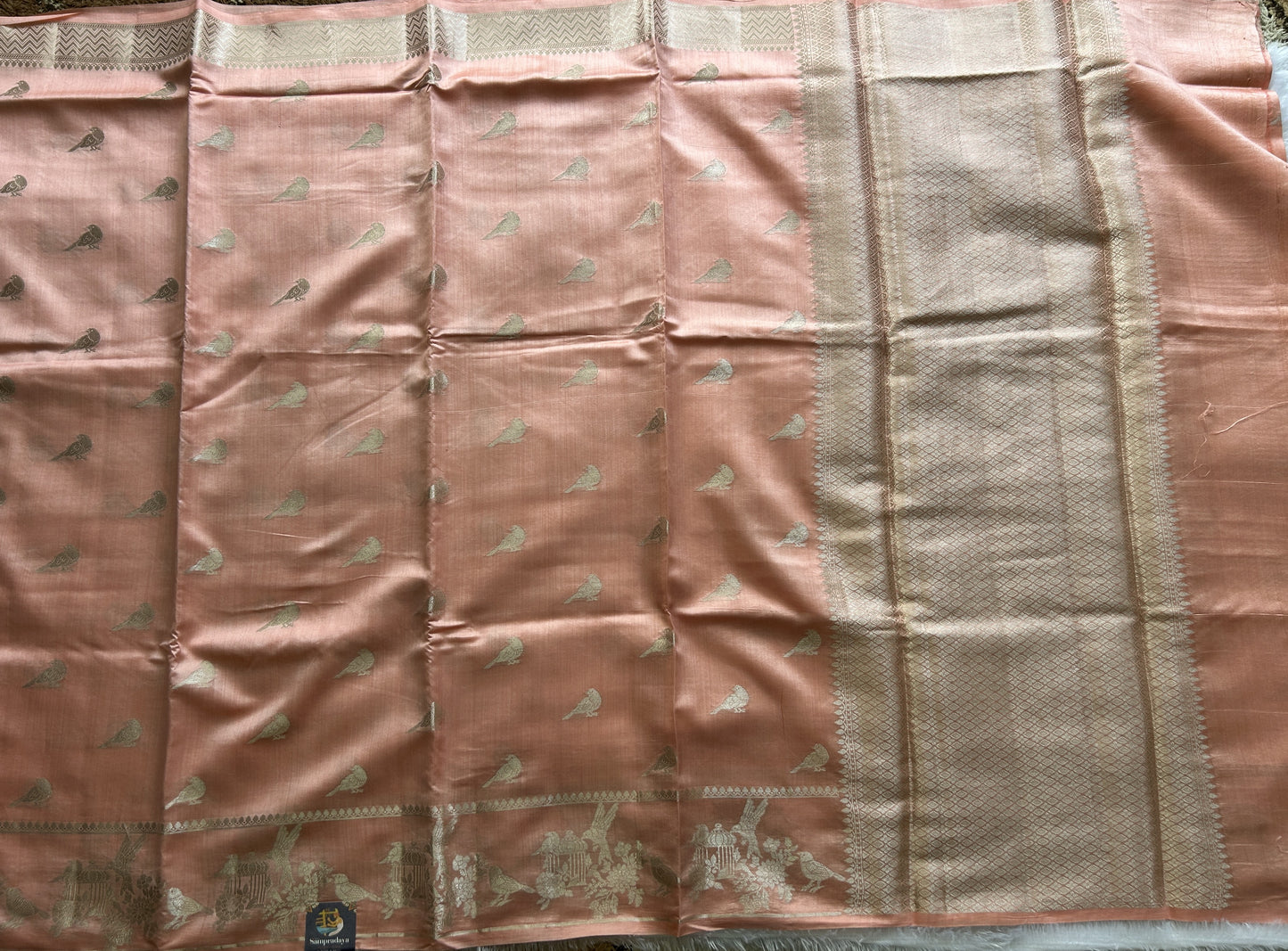 Pure Chiniya Silk Saree Peach Colored Elegantly Paired with a Gold Zari Border.