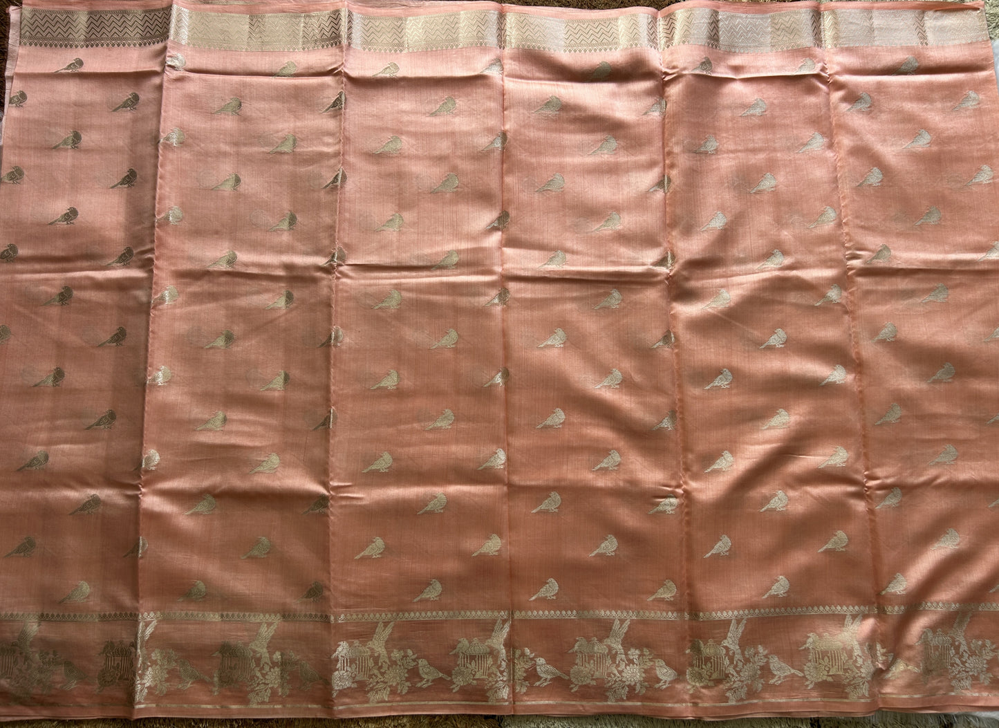 Pure Chiniya Silk Saree Peach Colored Elegantly Paired with a Gold Zari Border.