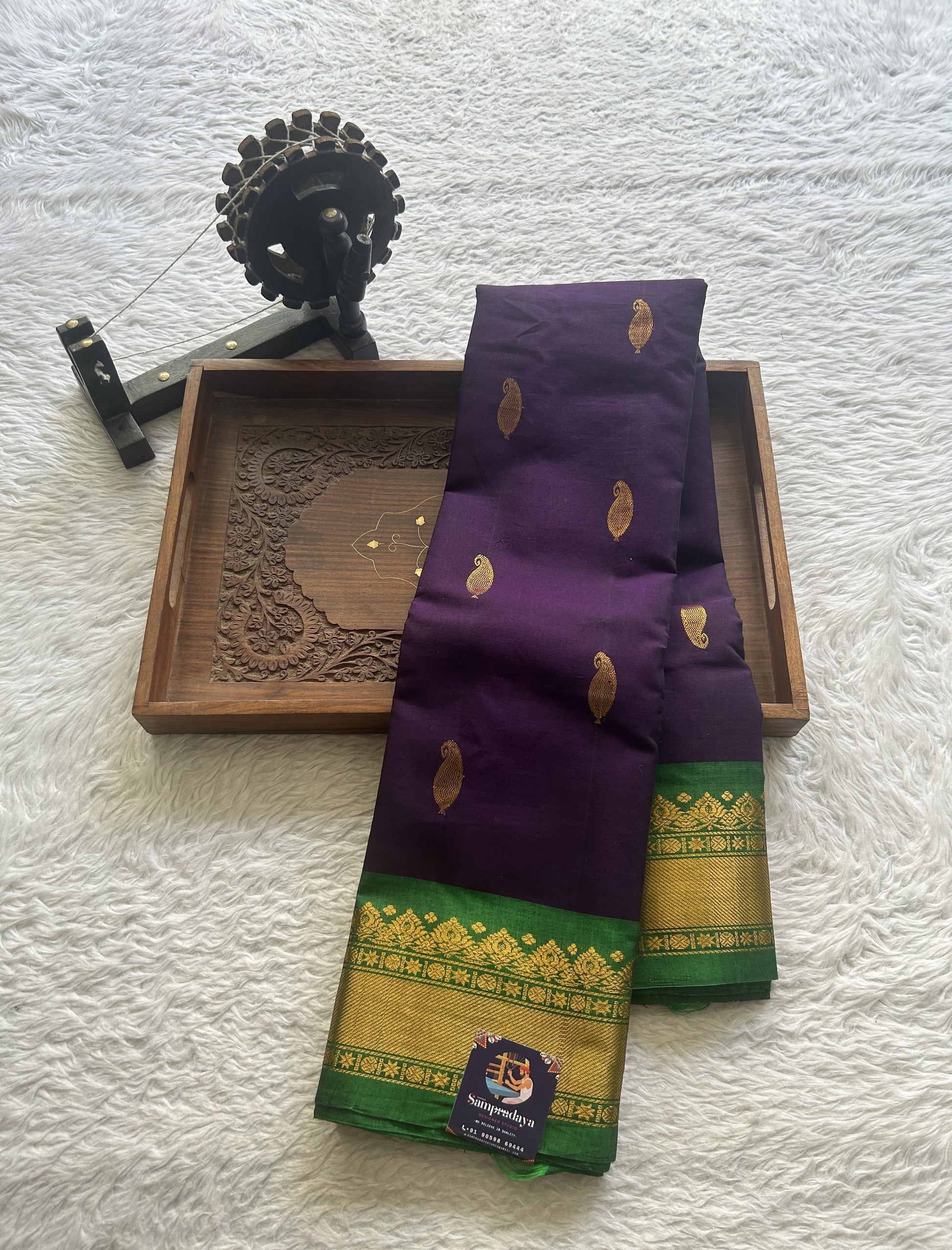 Gadwal Sico Saree Brinjal colored complemented with a Green Zari Border. - Sampradaya Designer Studio