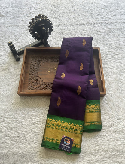 Gadwal Sico Saree Brinjal colored complemented with a Green Zari Border. - Sampradaya Designer Studio