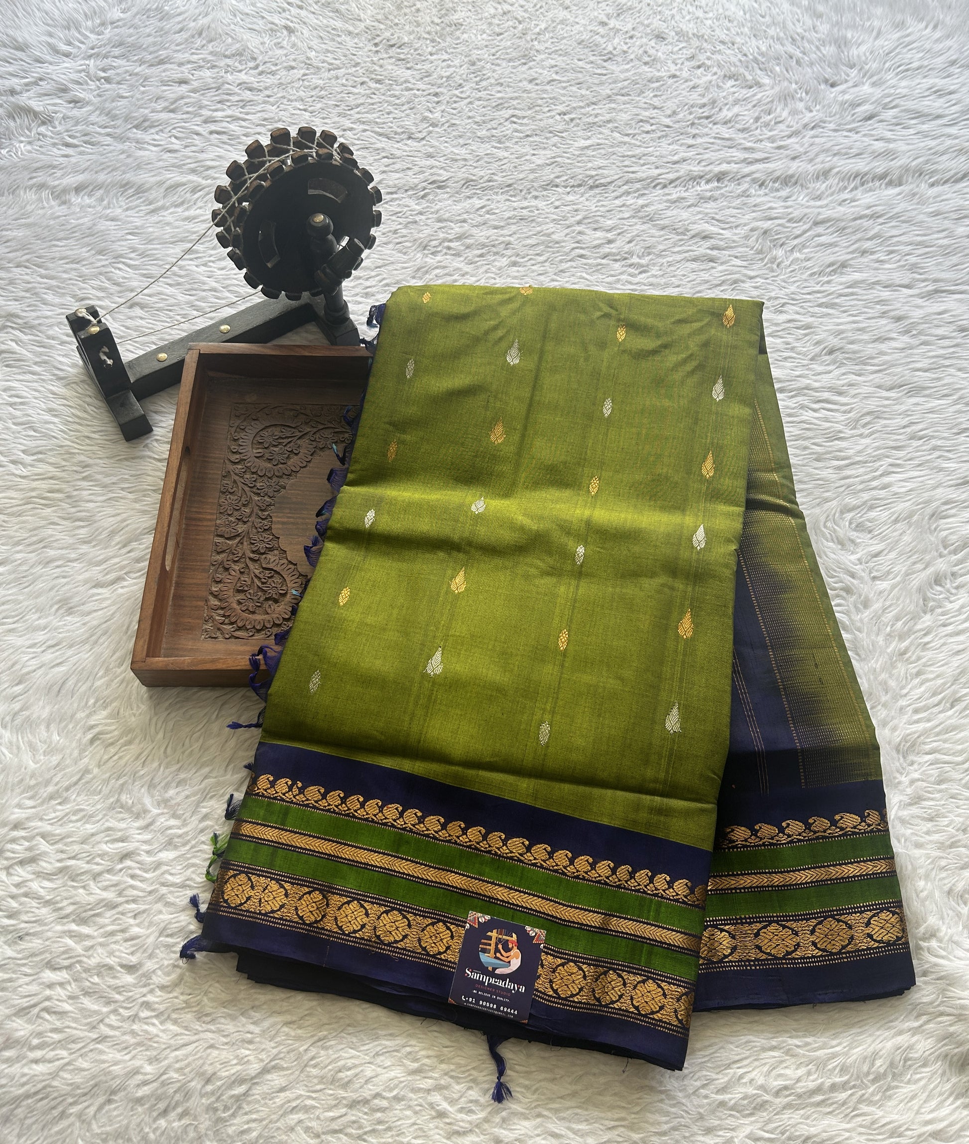 Gadwal Sico Saree Green colored complemented with a Blue Zari Border. - Sampradaya Designer Studio