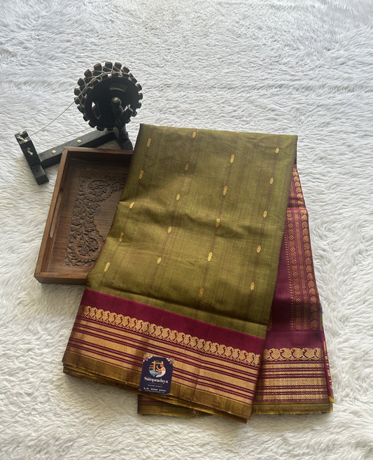 Gadwal Sico Saree Olive Green colored complemented with a Pink Zari Border. - Sampradaya Designer Studio