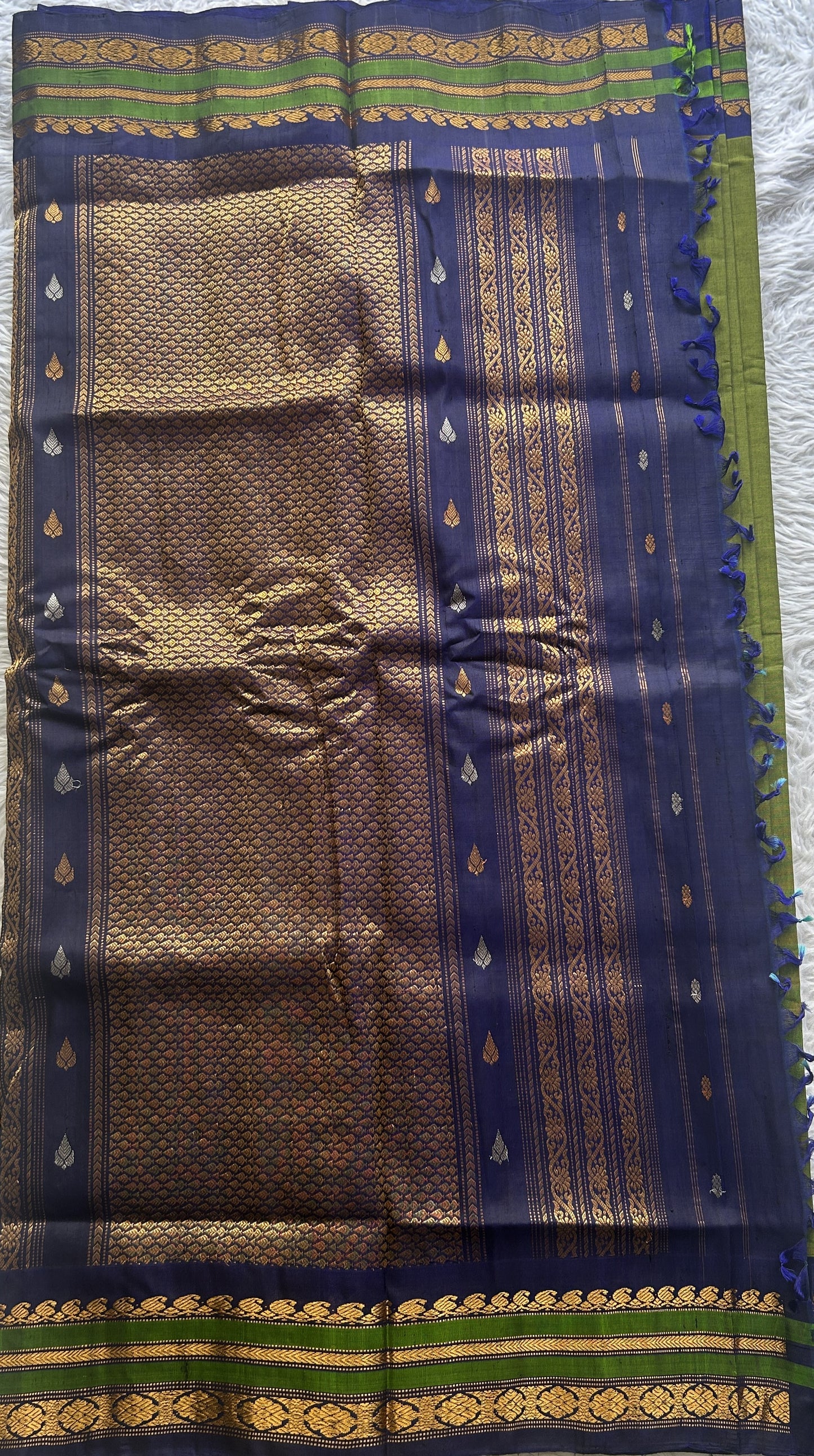 Gadwal Sico Saree Green colored complemented with a Blue Zari Border. - Sampradaya Designer Studio