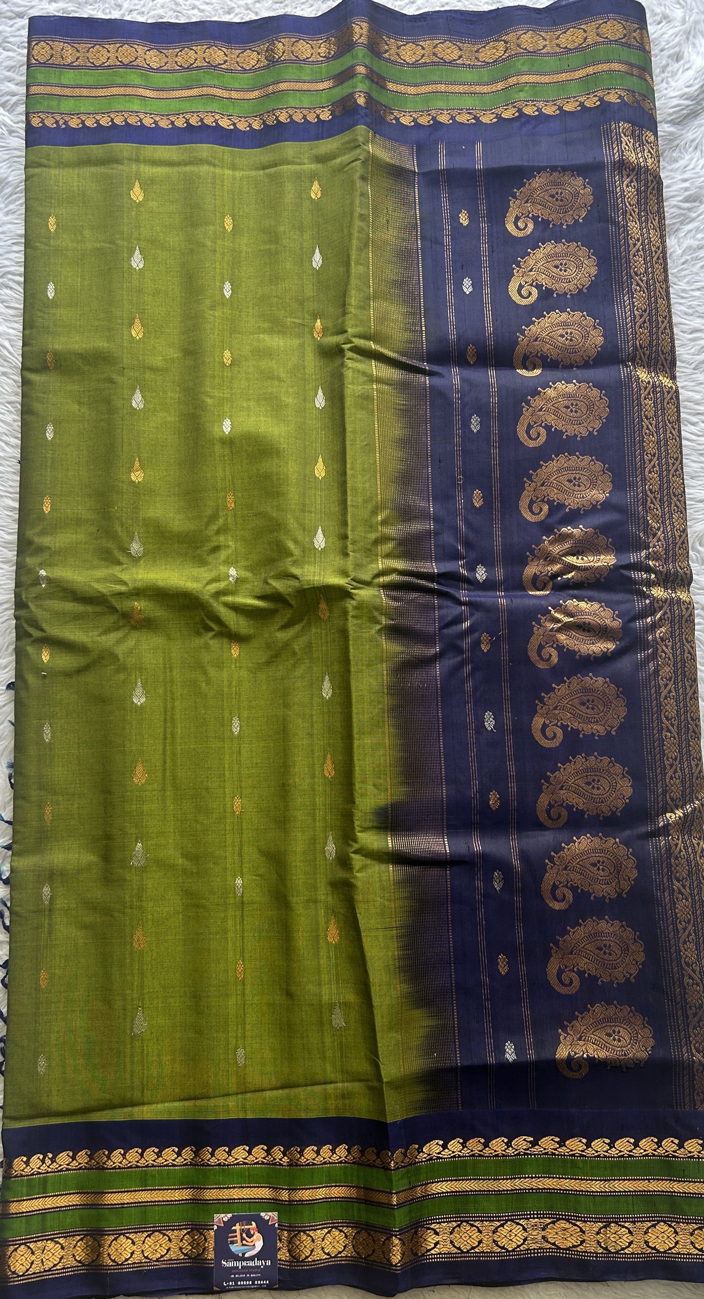 Gadwal Sico Saree Green colored complemented with a Blue Zari Border. - Sampradaya Designer Studio