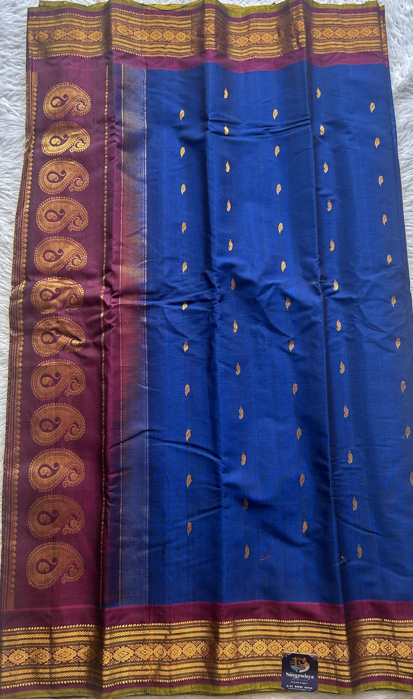Gadwal Sico Saree Ink Blue colored complemented with a Purple Zari Border. - Sampradaya Designer Studio
