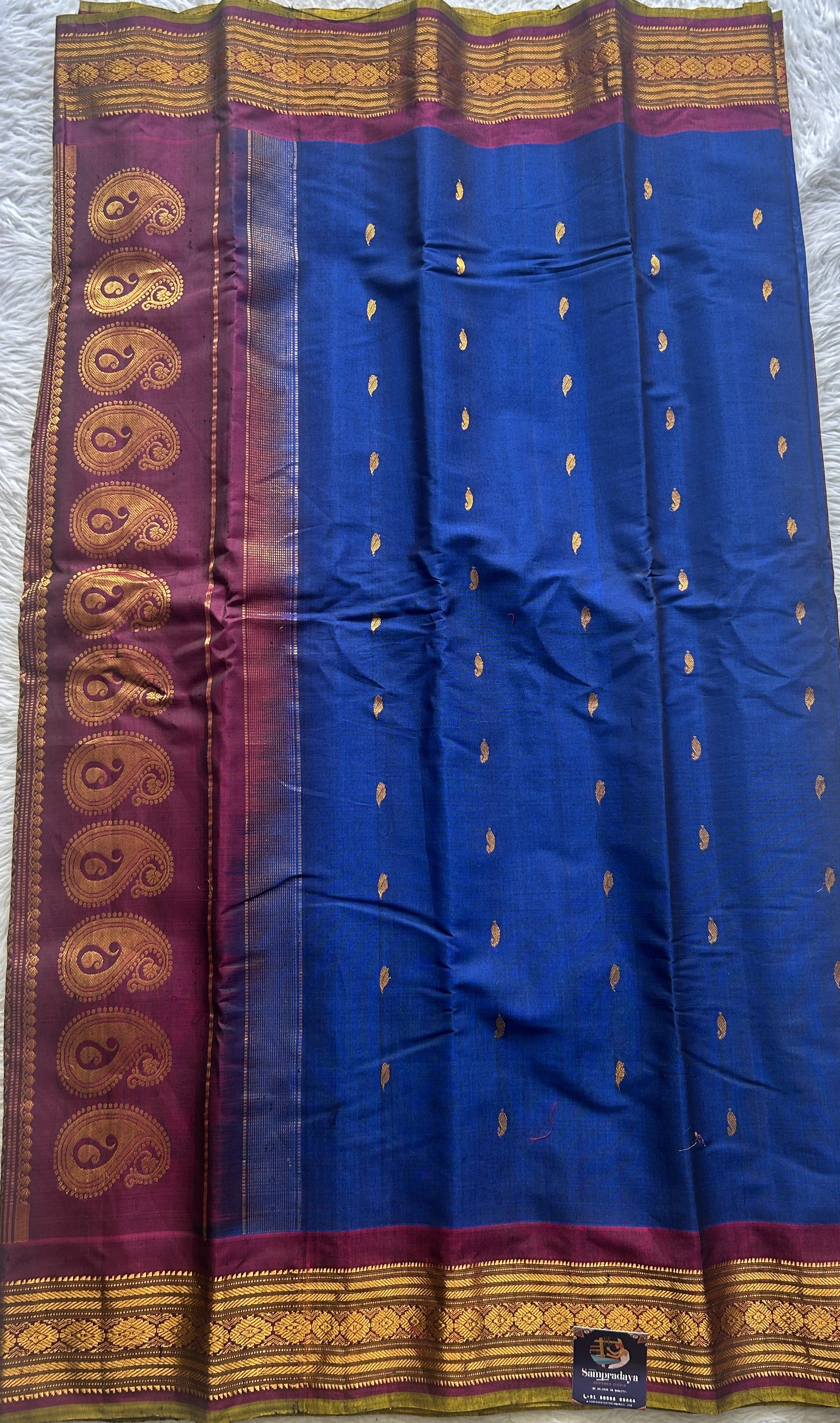 Gadwal Sico Saree Ink Blue colored complemented with a Purple Zari Border. - Sampradaya Designer Studio