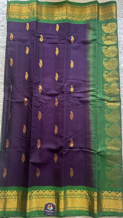 Gadwal Sico Saree Brinjal colored complemented with a Green Zari Border. - Sampradaya Designer Studio