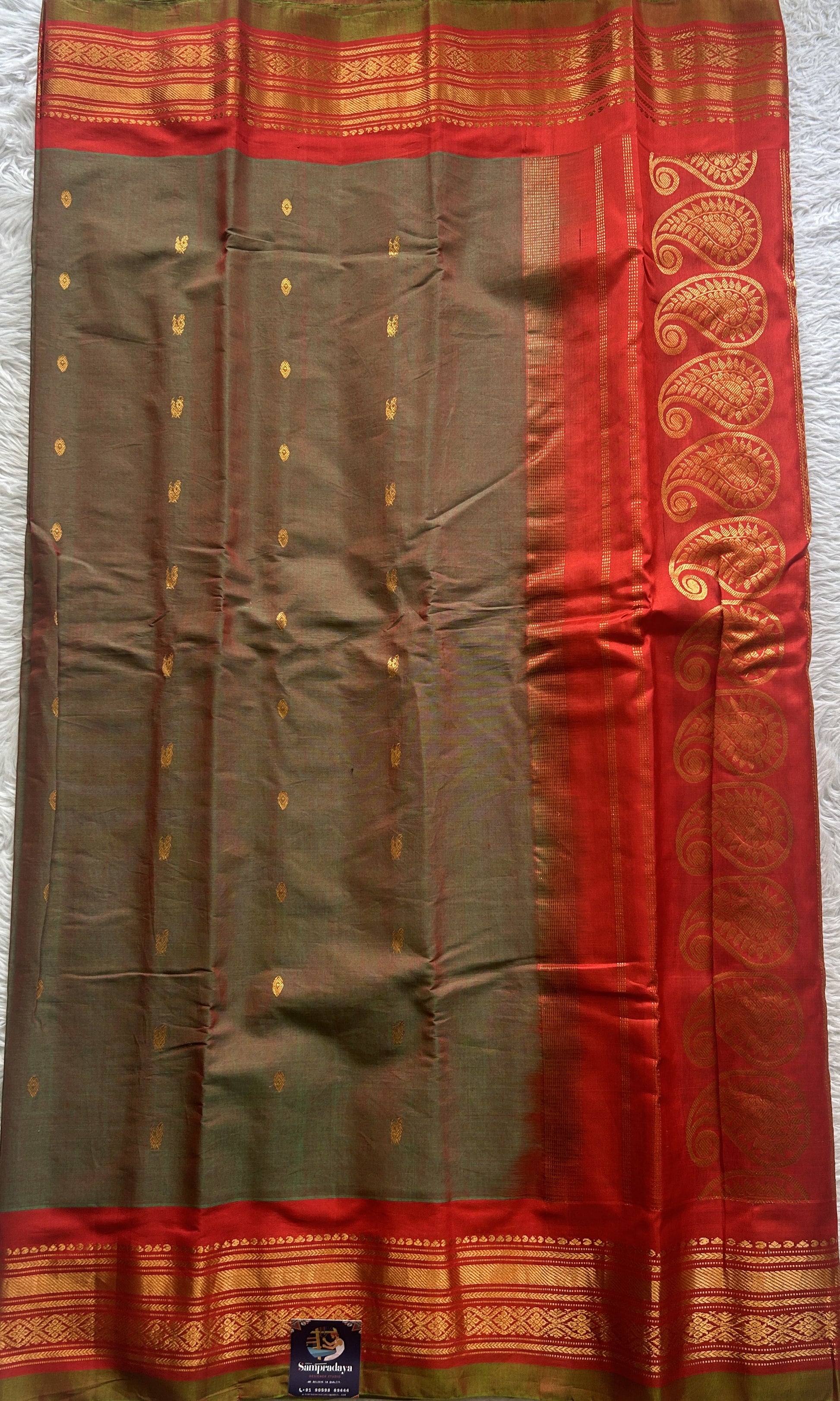 Gadwal Sico Saree Olive Green colored complemented with a Red Zari Border. - Sampradaya Designer Studio