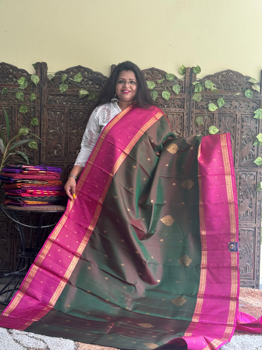 Pure Kanjivaram Silk Saree Dark Green Colored Complemented with Pink color Border with a Gold Zari Weaving. - Sampradaya Designer Studio