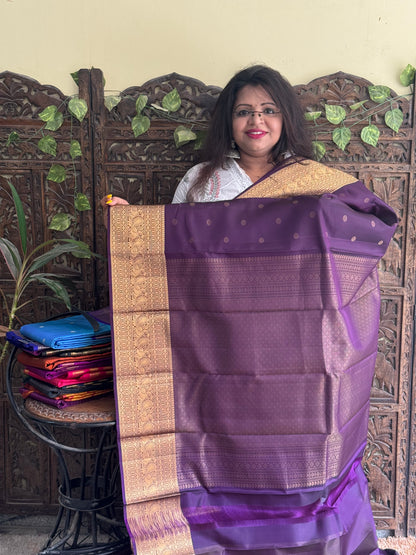 Pure Kanjivaram Silk Saree Dark Purple Complemented with a Gold Zari Border. - Sampradaya Designer Studio