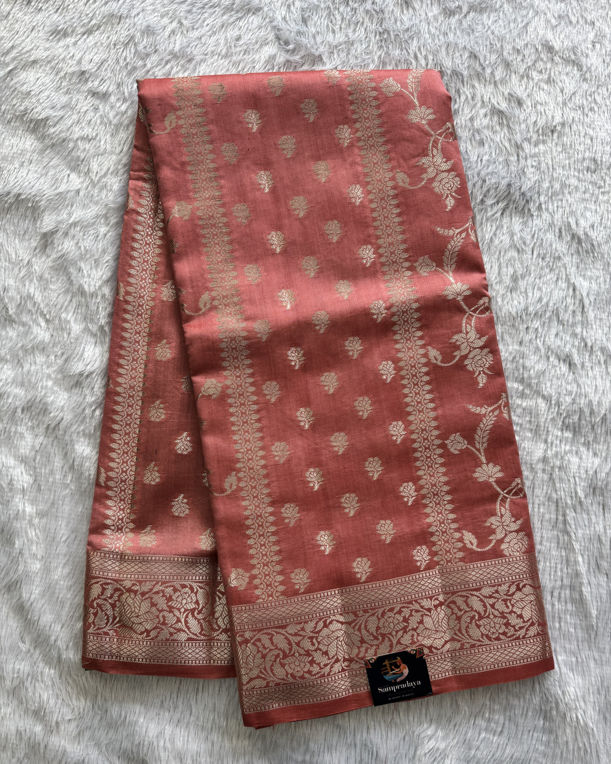 Pure Chiniya Silk Saree Peach Colored Elegantly Paired with a Gold Zari Border.