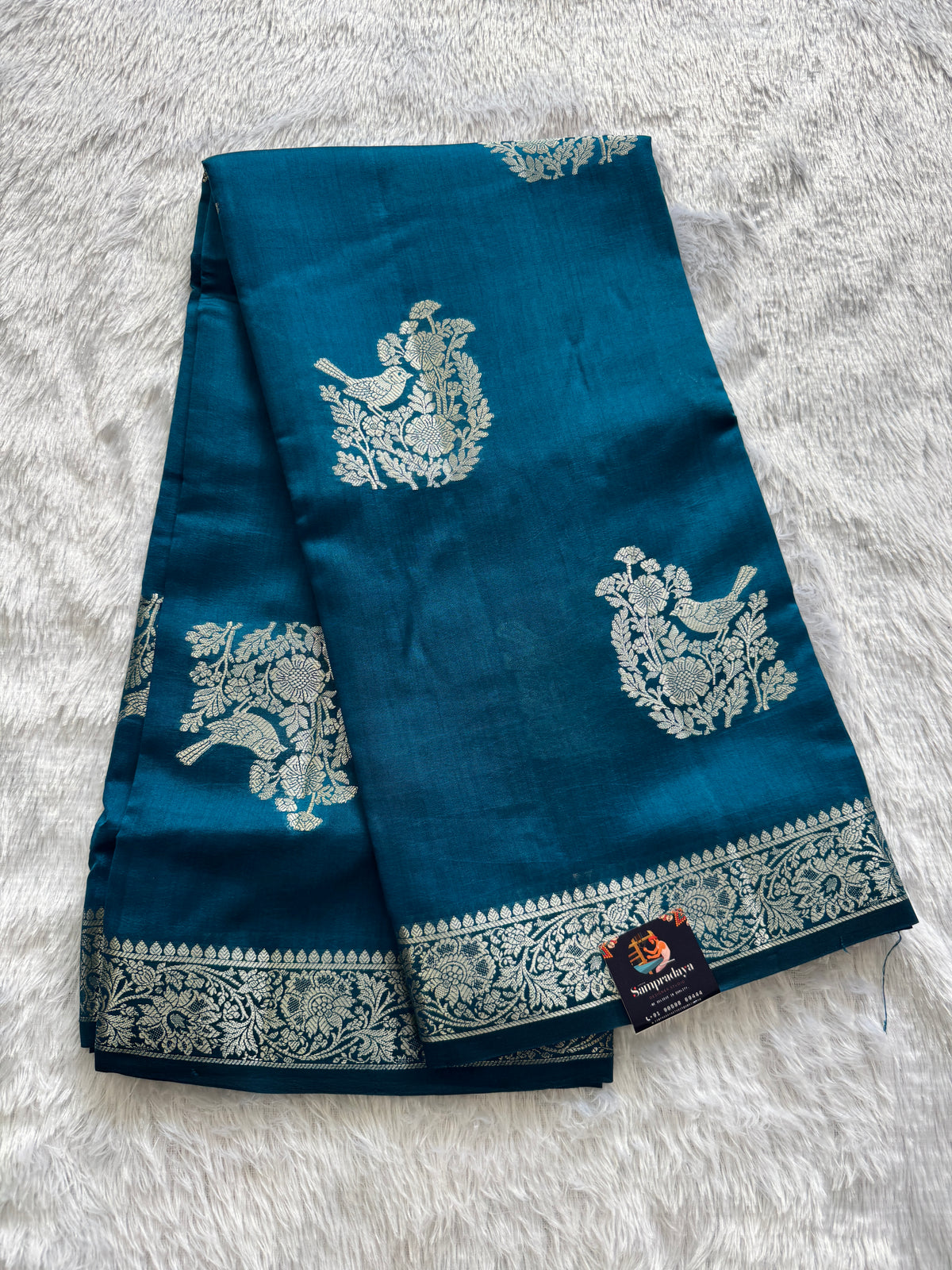 Pure Chiniya Silk Saree Peacock Blue Colored Elegantly Paired with a Gold Zari Border.