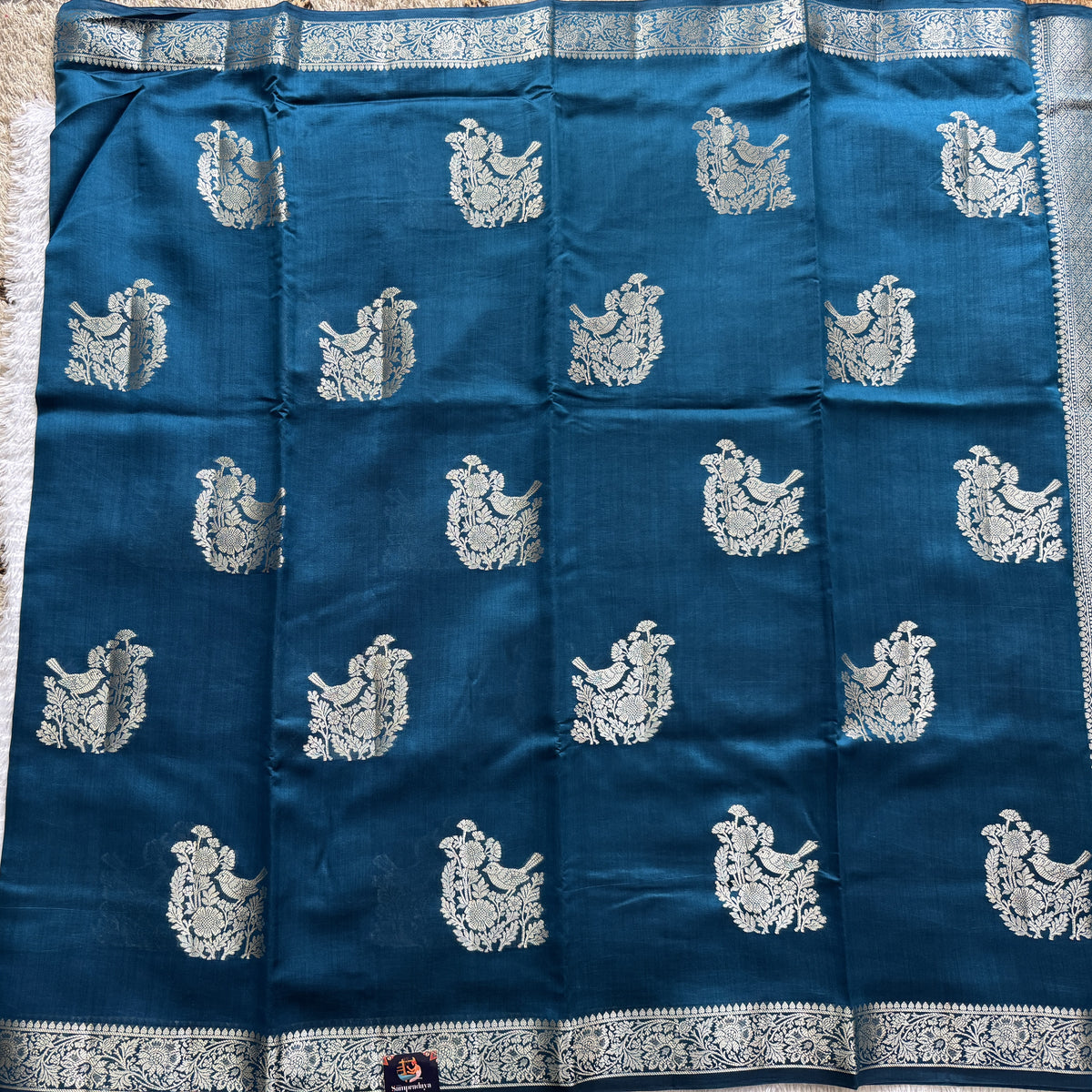 Pure Chiniya Silk Saree Peacock Blue Colored Elegantly Paired with a Gold Zari Border.