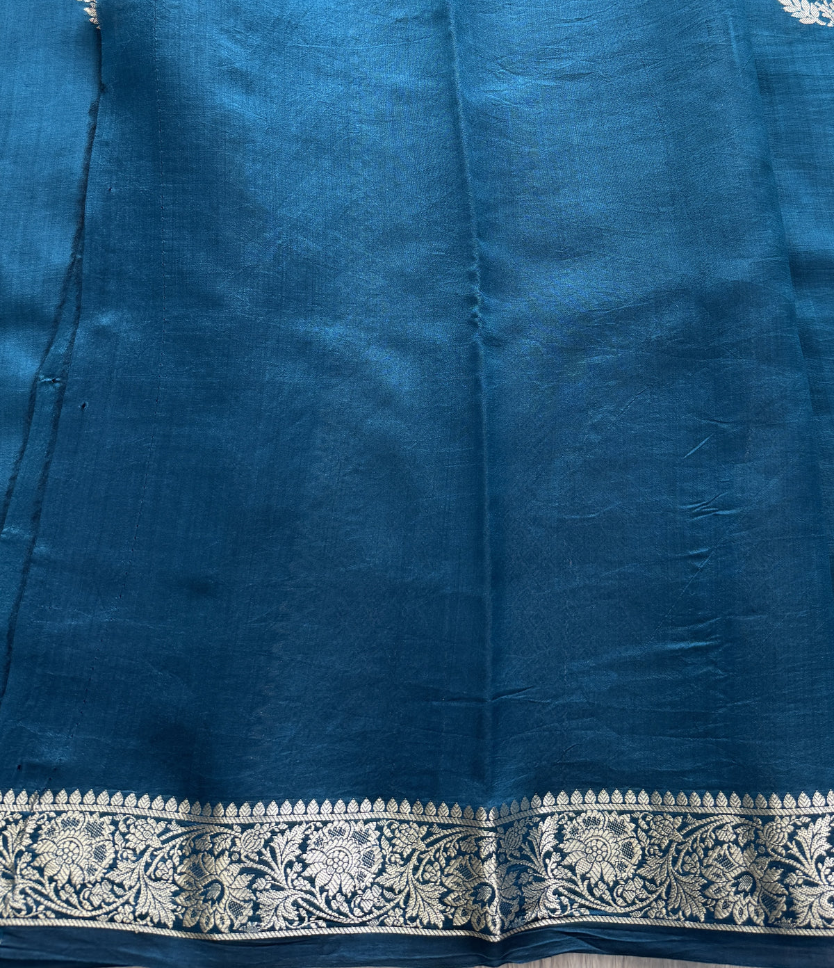 Pure Chiniya Silk Saree Peacock Blue Colored Elegantly Paired with a Gold Zari Border.