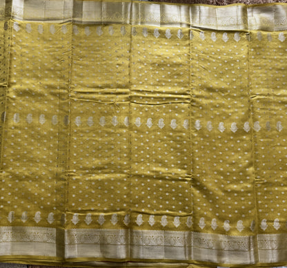 Pure Chiniya Silk Saree Yellow Colored Elegantly Paired with a Gold Zari Border.