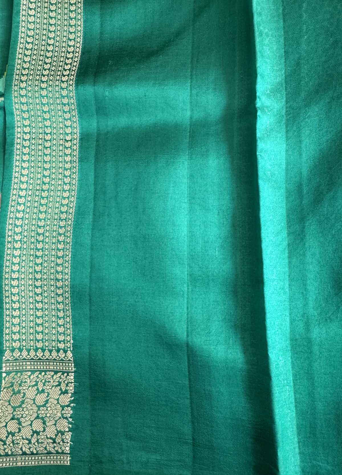 Pure Chiniya Silk Saree Rama Green Colored Elegantly Paired with a Gold Zari Border.