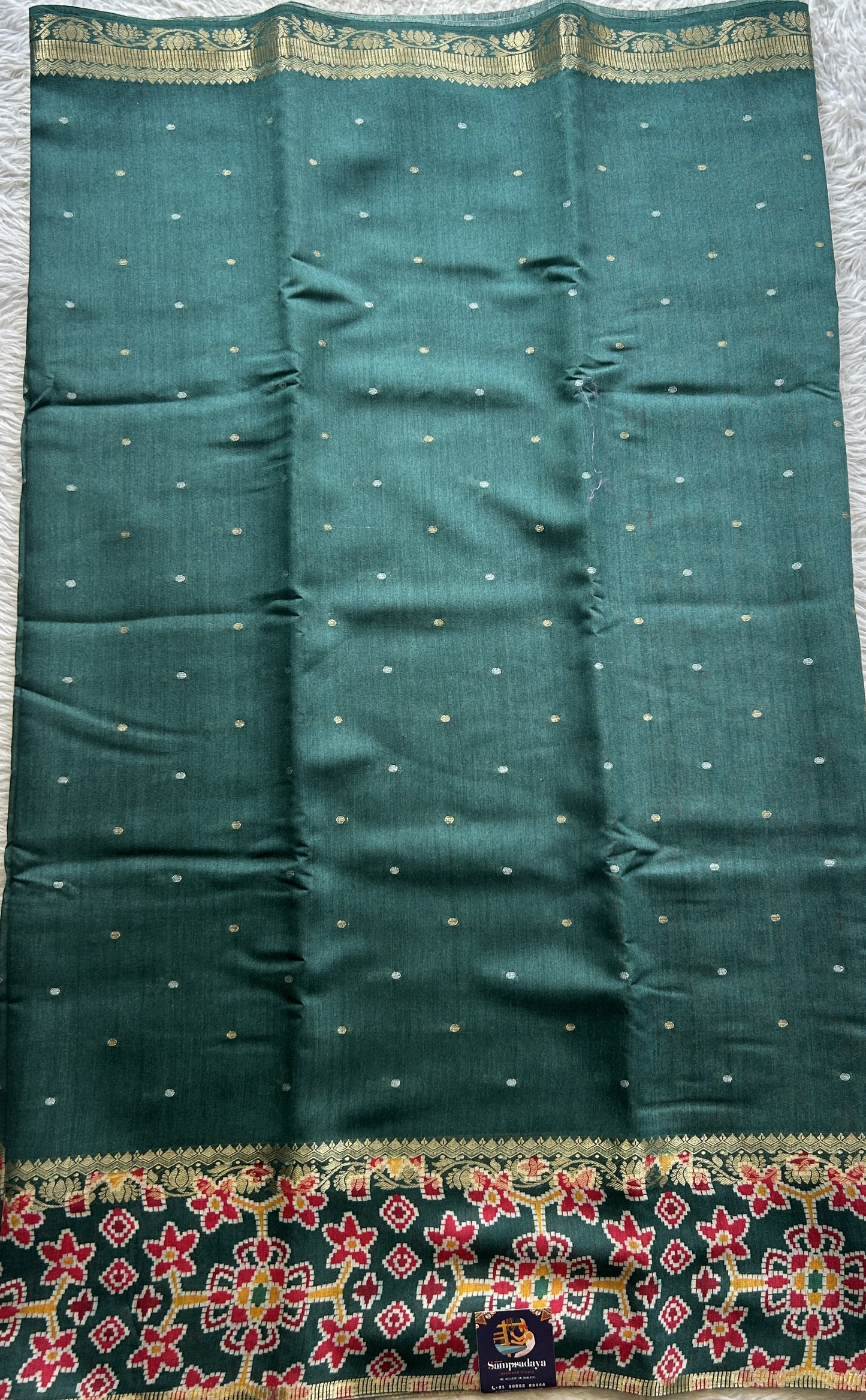 Pure Moonga Tussar Silk Saree Peacock Green Color Complemented with a Patolla Border. - Sampradaya Designer Studio