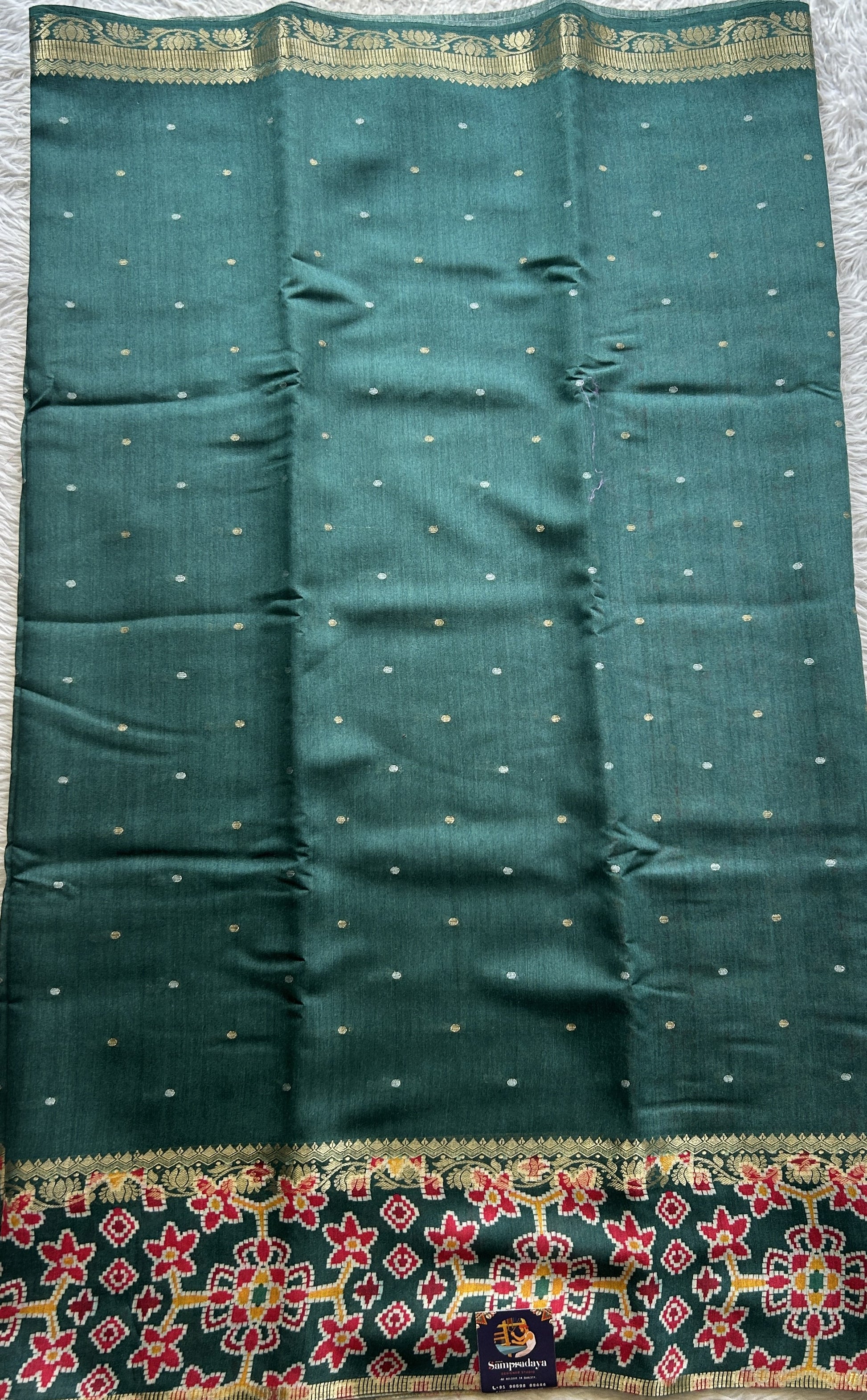 Pure Moonga Tussar Silk Saree Peacock Green Color Complemented with a Patolla Border. - Sampradaya Designer Studio