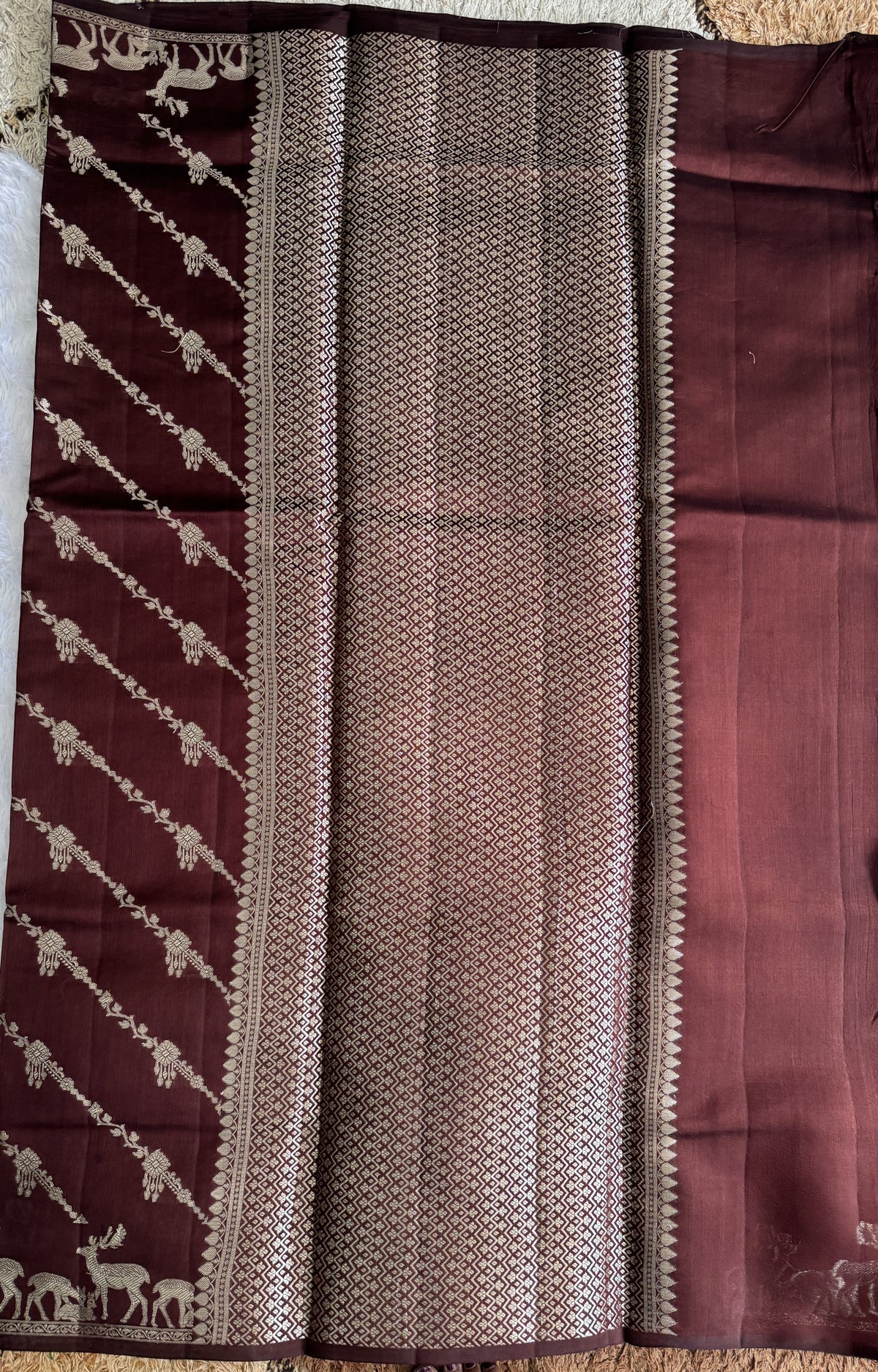 Pure Chiniya Silk Saree Brown Colored Elegantly Paired with a Gold Zari Border.