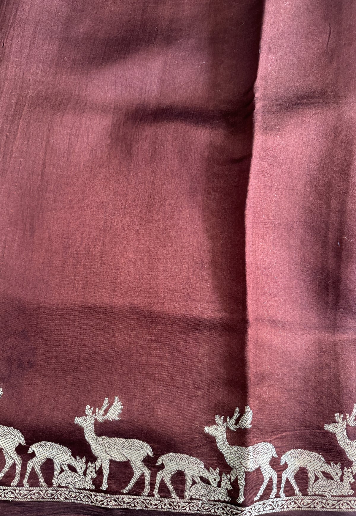 Pure Chiniya Silk Saree Brown Colored Elegantly Paired with a Gold Zari Border.