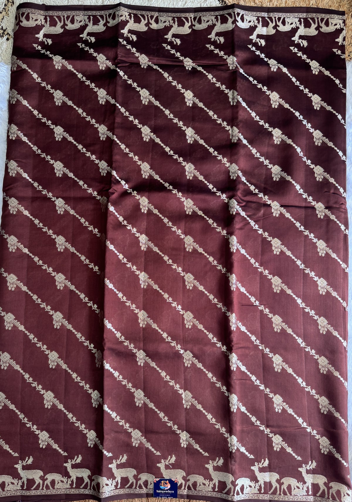 Pure Chiniya Silk Saree Brown Colored Elegantly Paired with a Gold Zari Border.