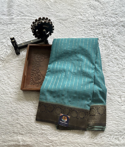 Semi Georgette Saree Aqua Blue Colored Elegantly Paired with a Zari Border. - Sampradaya Designer Studio
