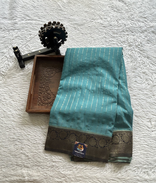 Semi Georgette Saree Aqua Blue Colored Elegantly Paired with a Zari Border. - Sampradaya Designer Studio