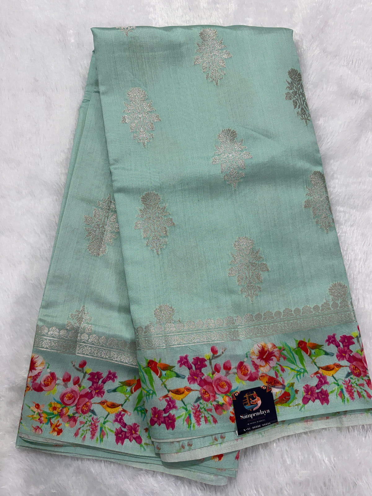 Pure Chiniya Silk Saree Ice Blue Colored Elegantly Paired with a Gold Zari Border.