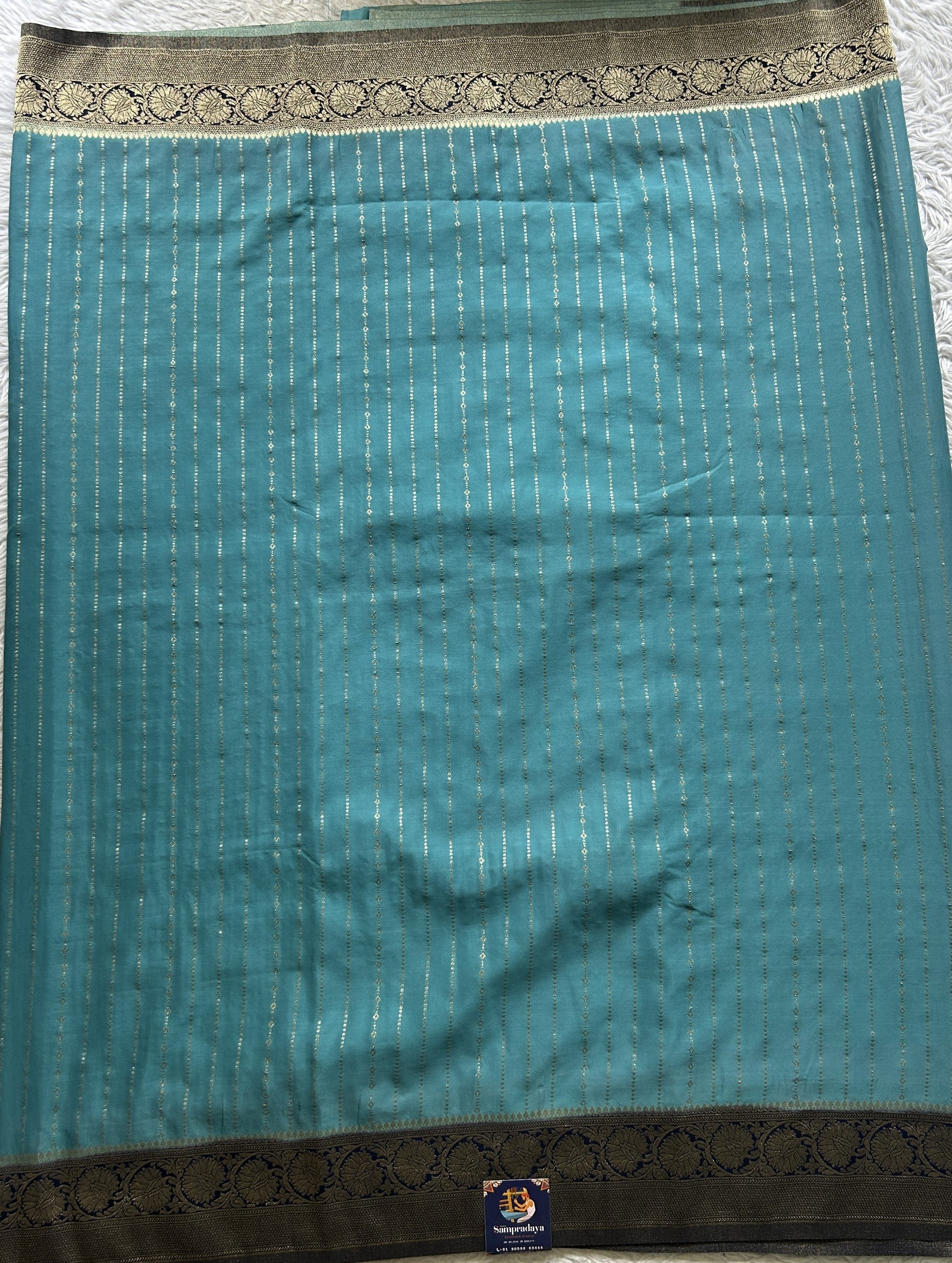 Semi Georgette Saree Aqua Blue Colored Elegantly Paired with a Zari Border. - Sampradaya Designer Studio