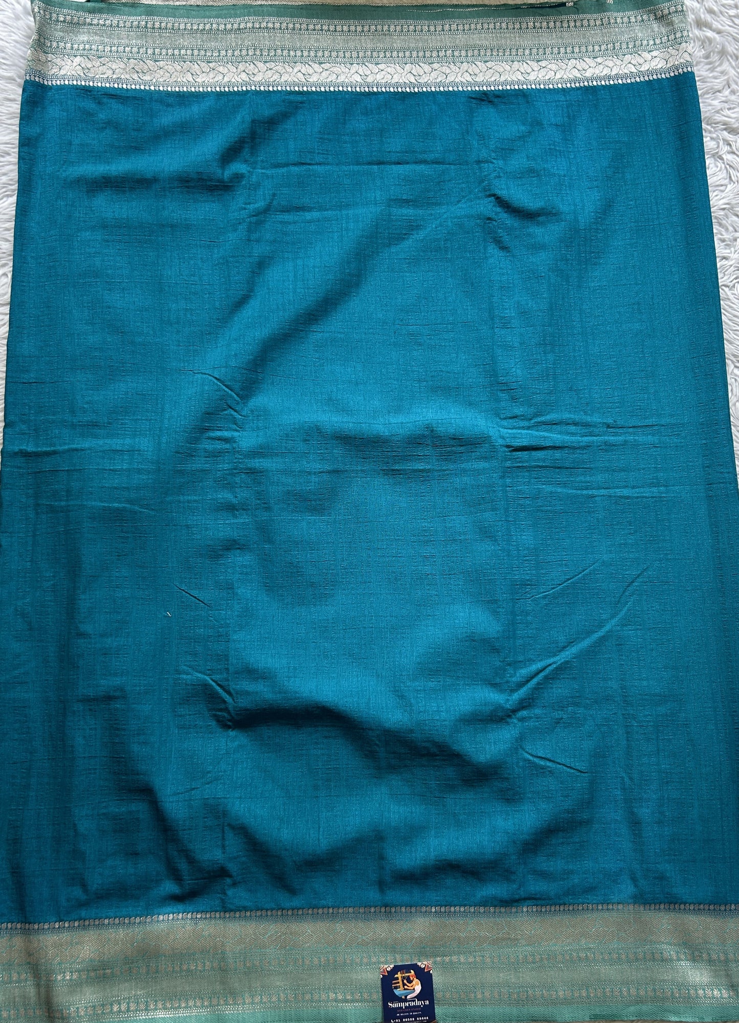 Semi Georgette Saree Sea Blue Colored Elegantly Paired with a Zari Border. - Sampradaya Designer Studio