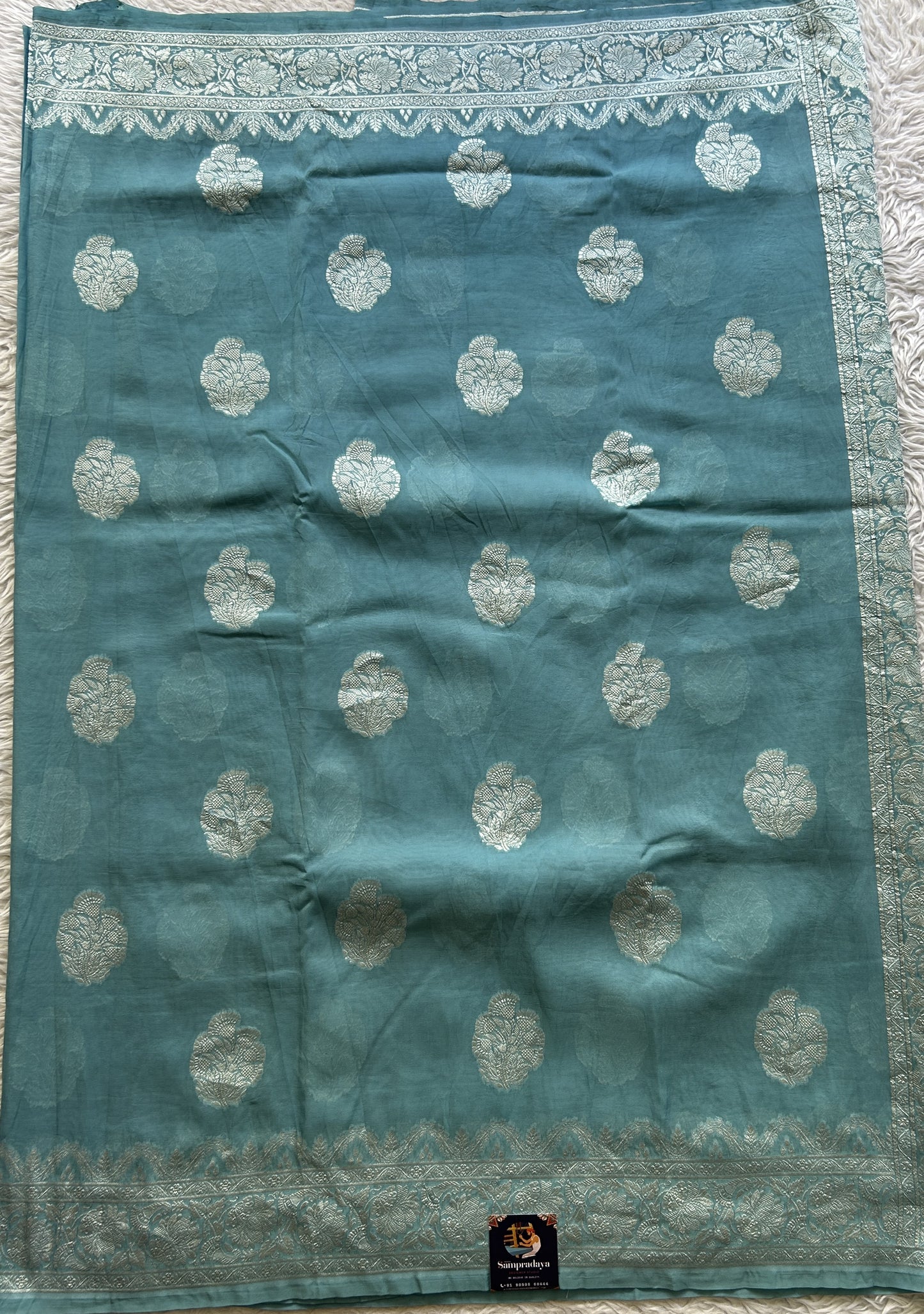 Banarasi Georgette Saree Light Sea Blue Colored Complemented with a Zari border. - Sampradaya Designer Studio