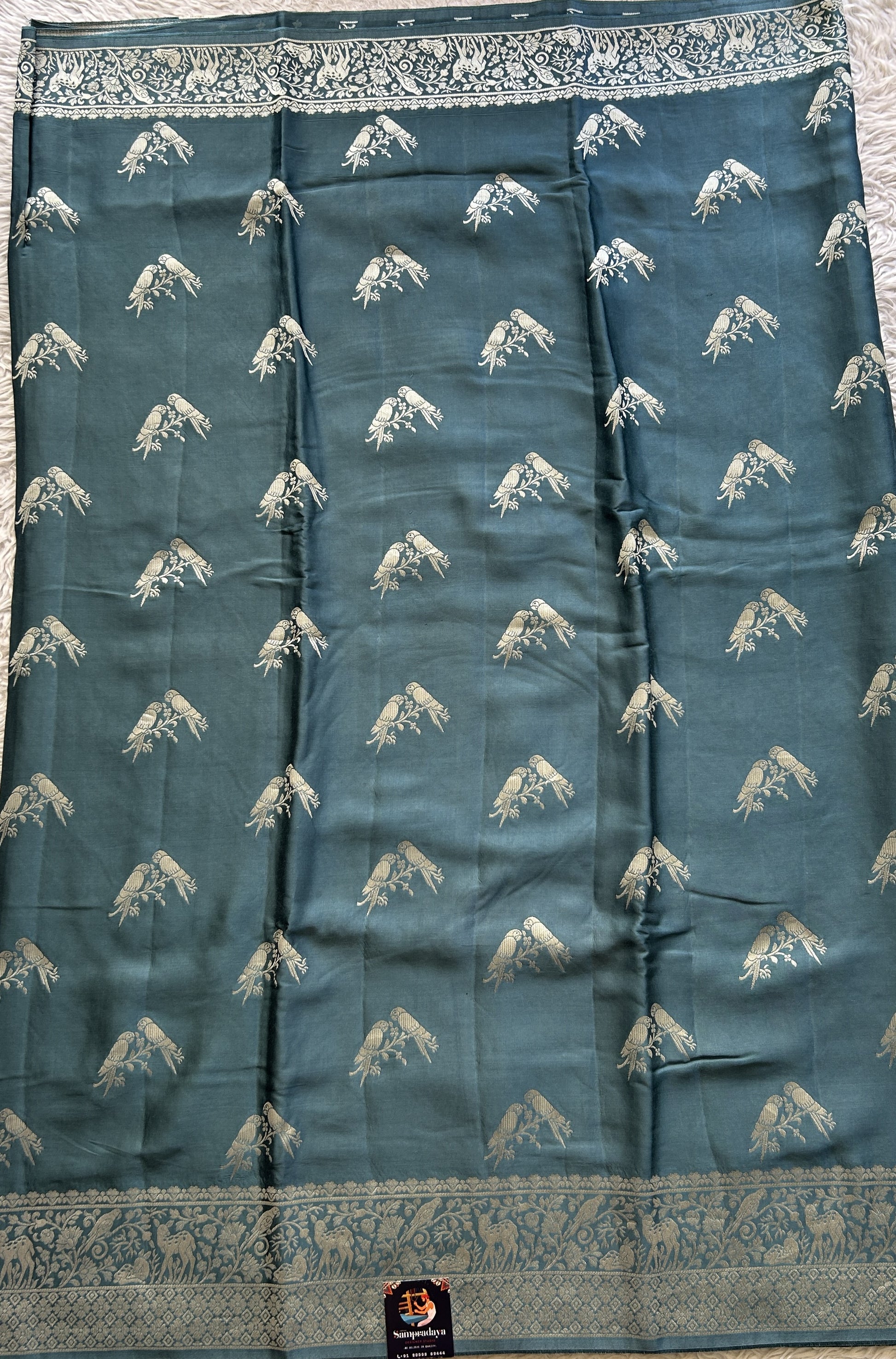 Banarasi Georgette Saree Teal Blue Colored Complemented with a Zari border. - Sampradaya Designer Studio