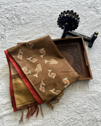 Semi Tussar Saree Brown colored complemented with a Red Color Zari Border. - Sampradaya Designer Studio