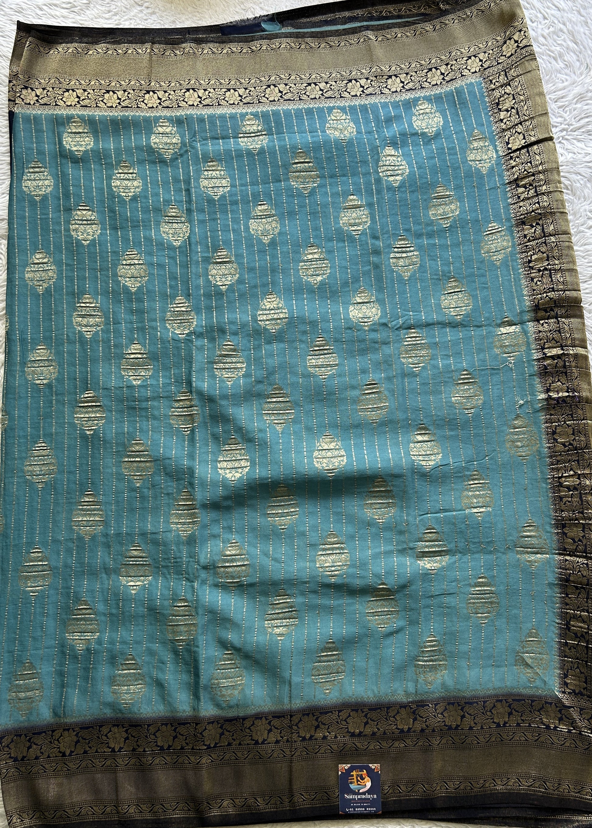 Semi Georgette Saree Sea Blue Colored Elegantly Paired with a Zari Border. - Sampradaya Designer Studio
