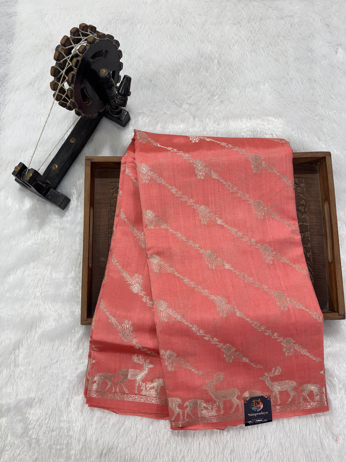 Pure Chiniya Silk Saree Peach Colored Elegantly Paired with a Gold Zari Border.