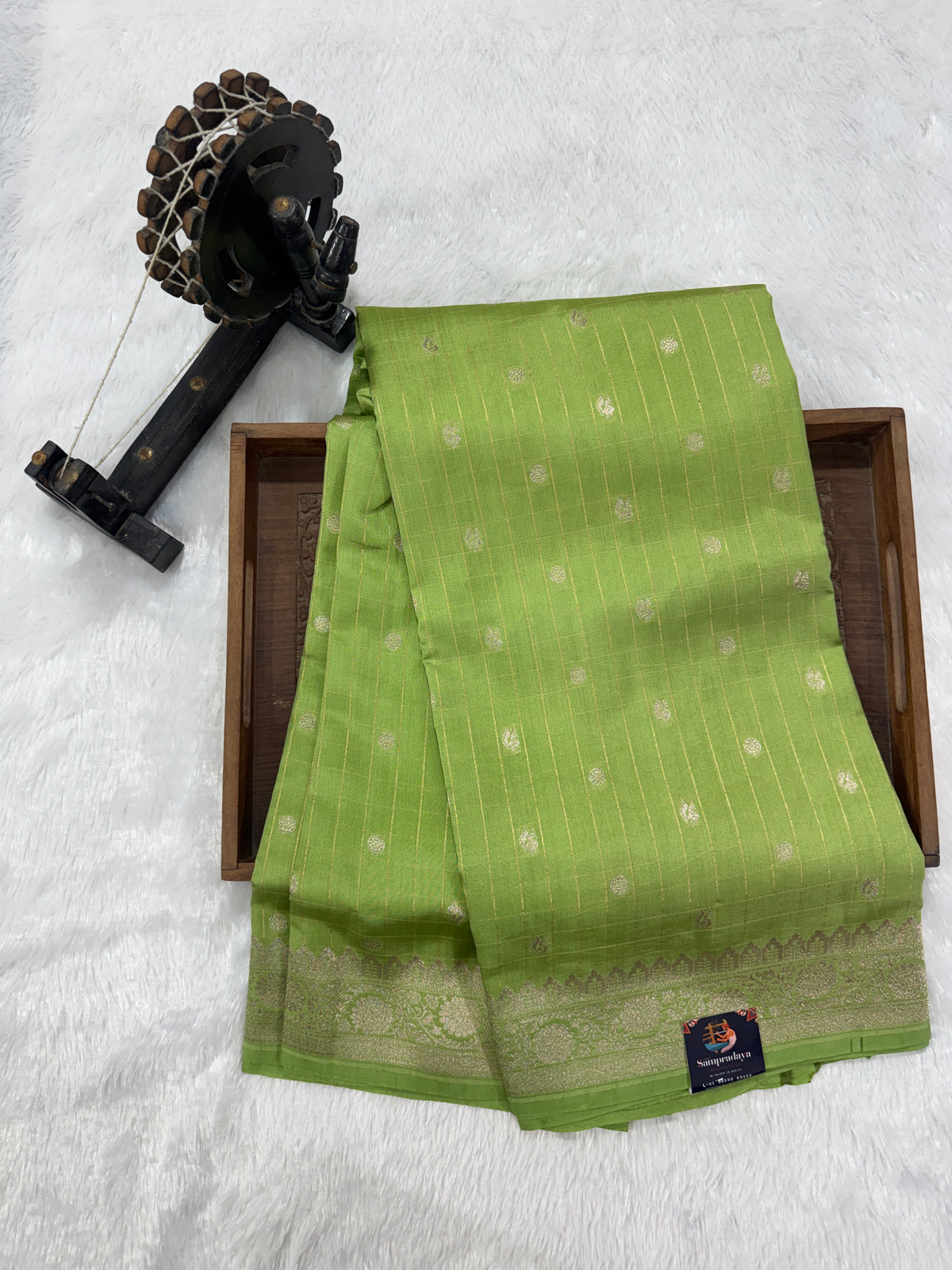 Pure Chiniya Silk Saree Apple Green Colored Elegantly Paired with a Gold Zari Border.