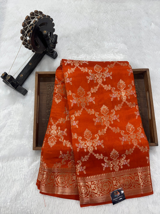 Pure Chiniya Silk Saree Orange Colored Elegantly Paired with a Gold Zari Border.