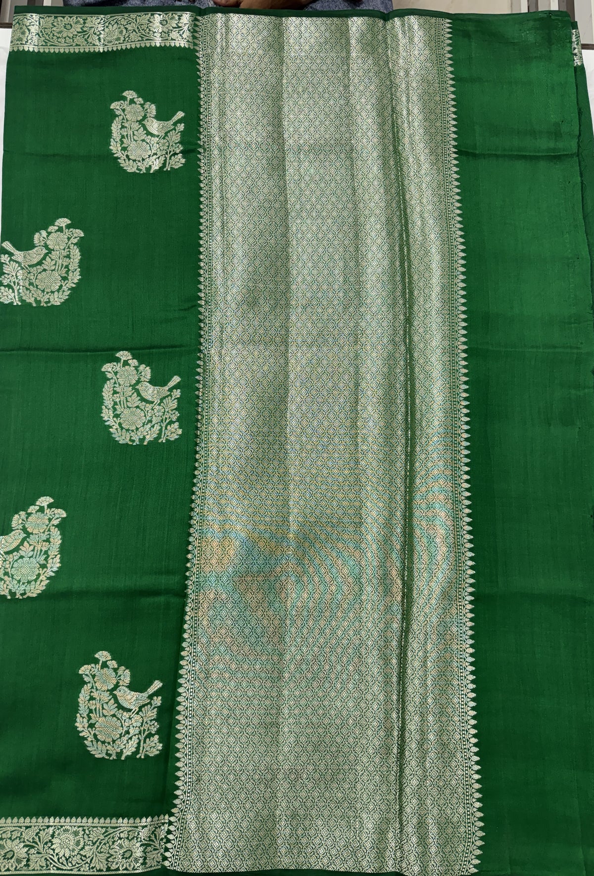 Pure Chiniya Silk Saree Bottle Green Colored Elegantly Paired with a Gold Zari Border.