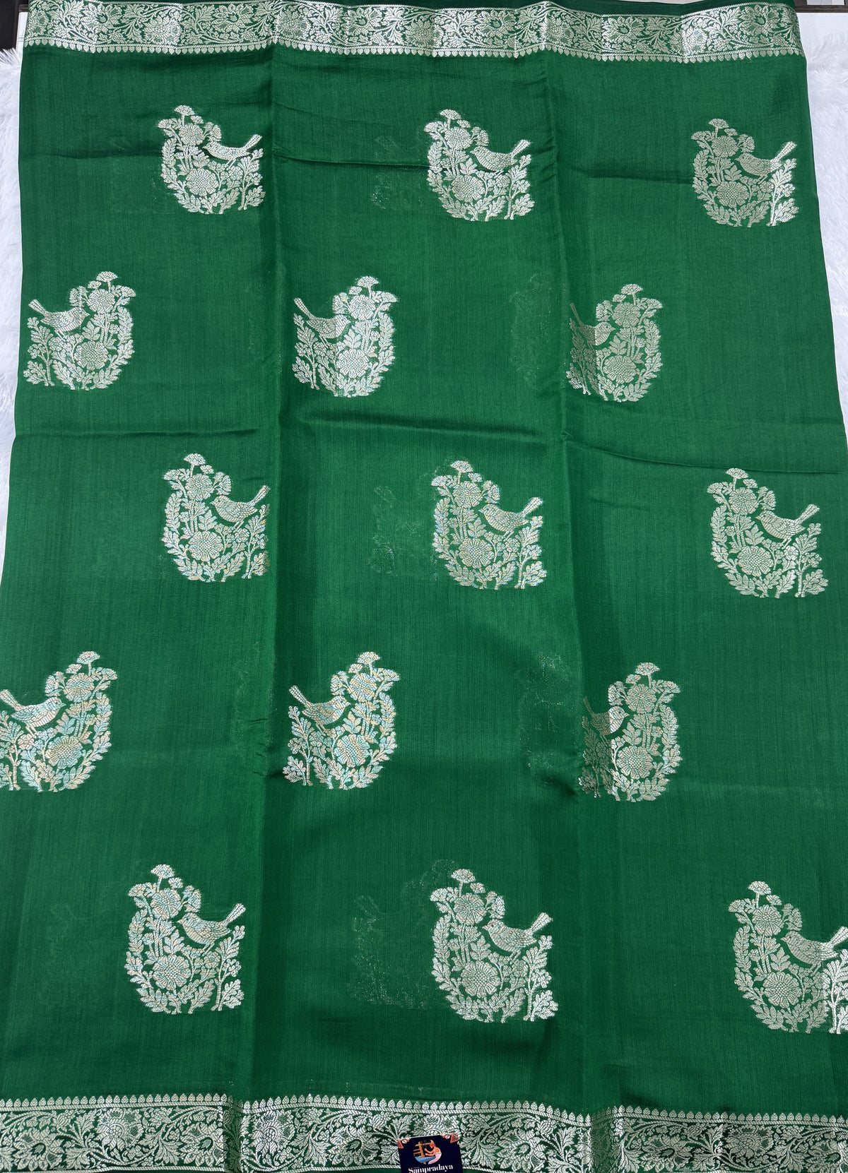 Pure Chiniya Silk Saree Bottle Green Colored Elegantly Paired with a Gold Zari Border.