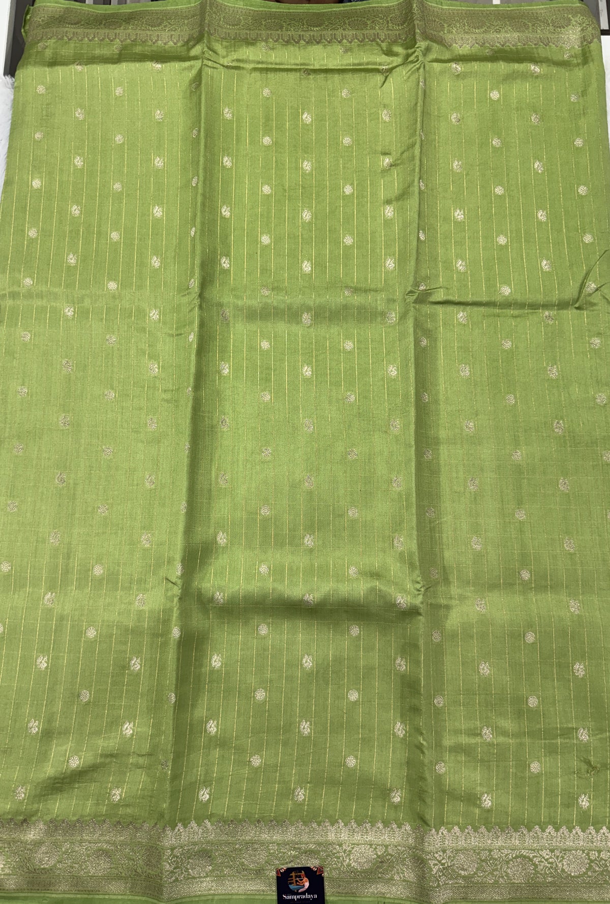 Pure Chiniya Silk Saree Apple Green Colored Elegantly Paired with a Gold Zari Border.