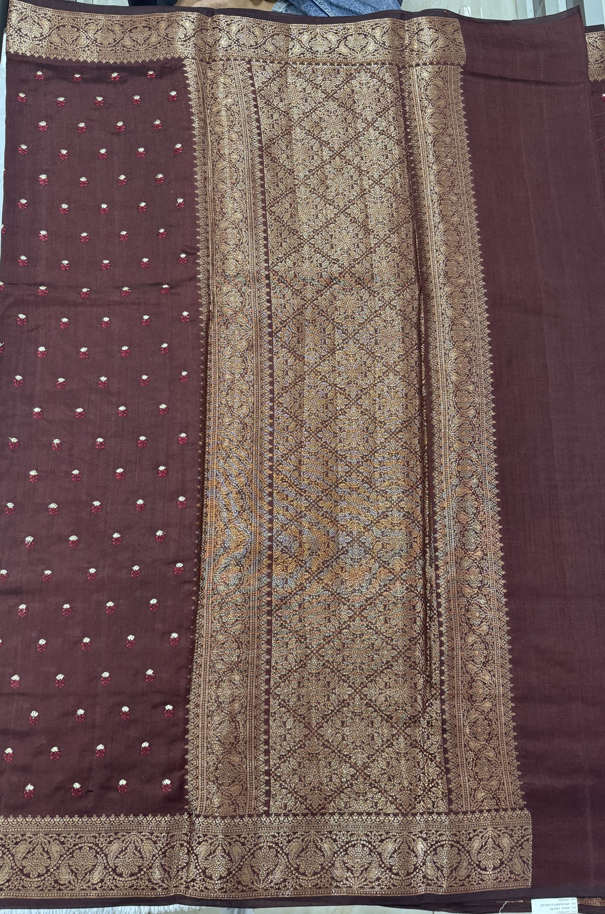 Pure Chiniya Silk Saree Brown Colored Elegantly Paired with a Gold Zari Border.