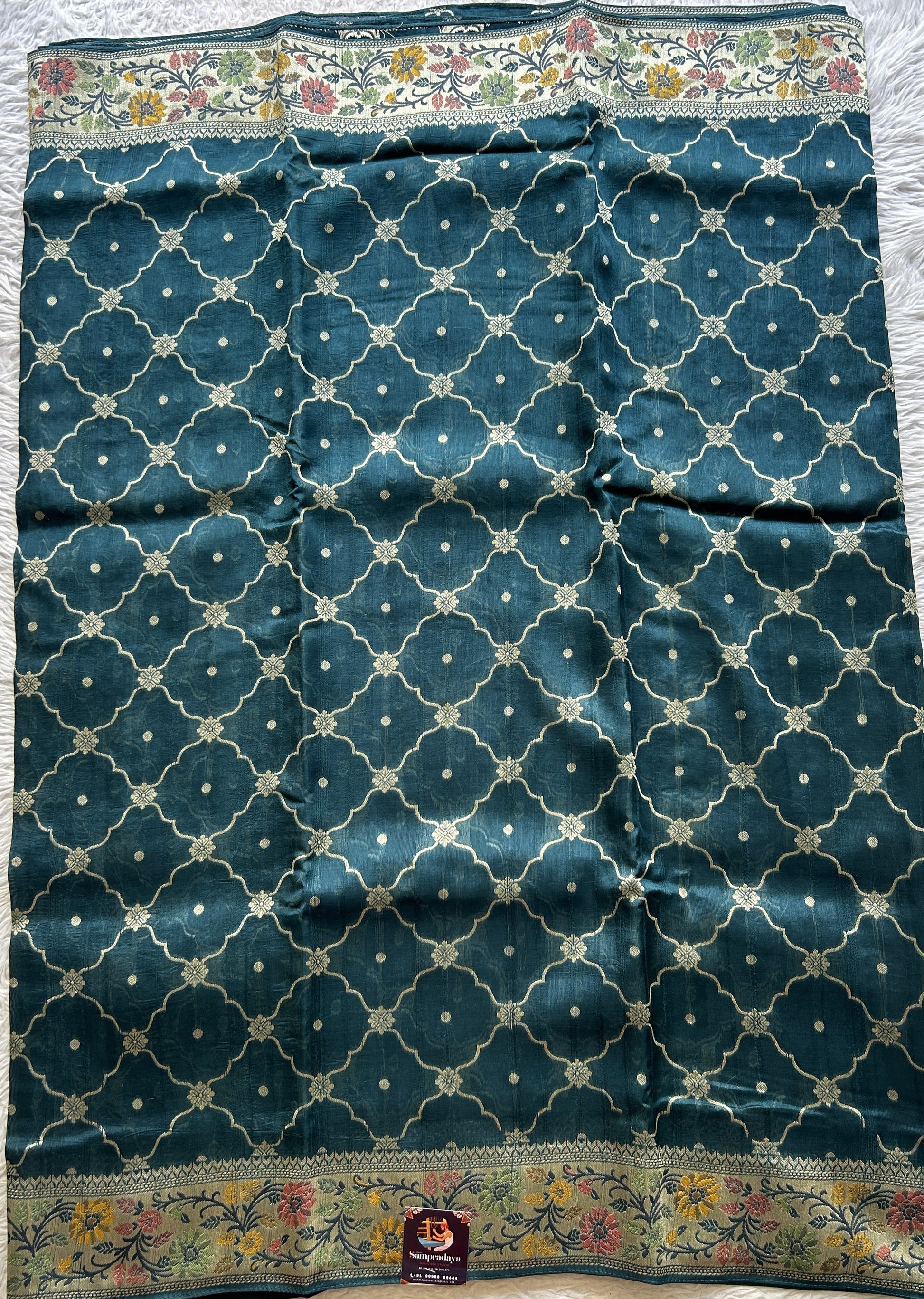 Banarasi Tussar Georgette Saree Peacock Blue Colored Complemented with a Minakari border. - Sampradaya Designer Studio