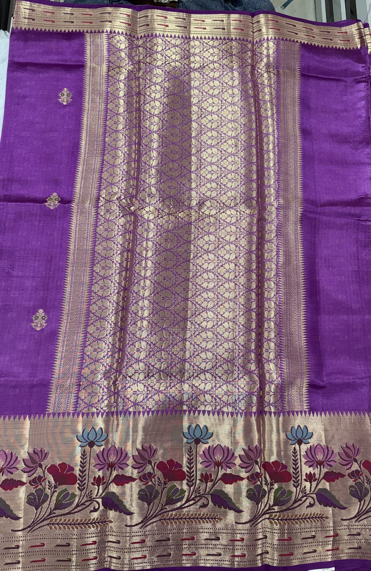 Pure Chiniya Silk Saree Striking Purple Colored Elegantly Paired with a Gold Zari Border.