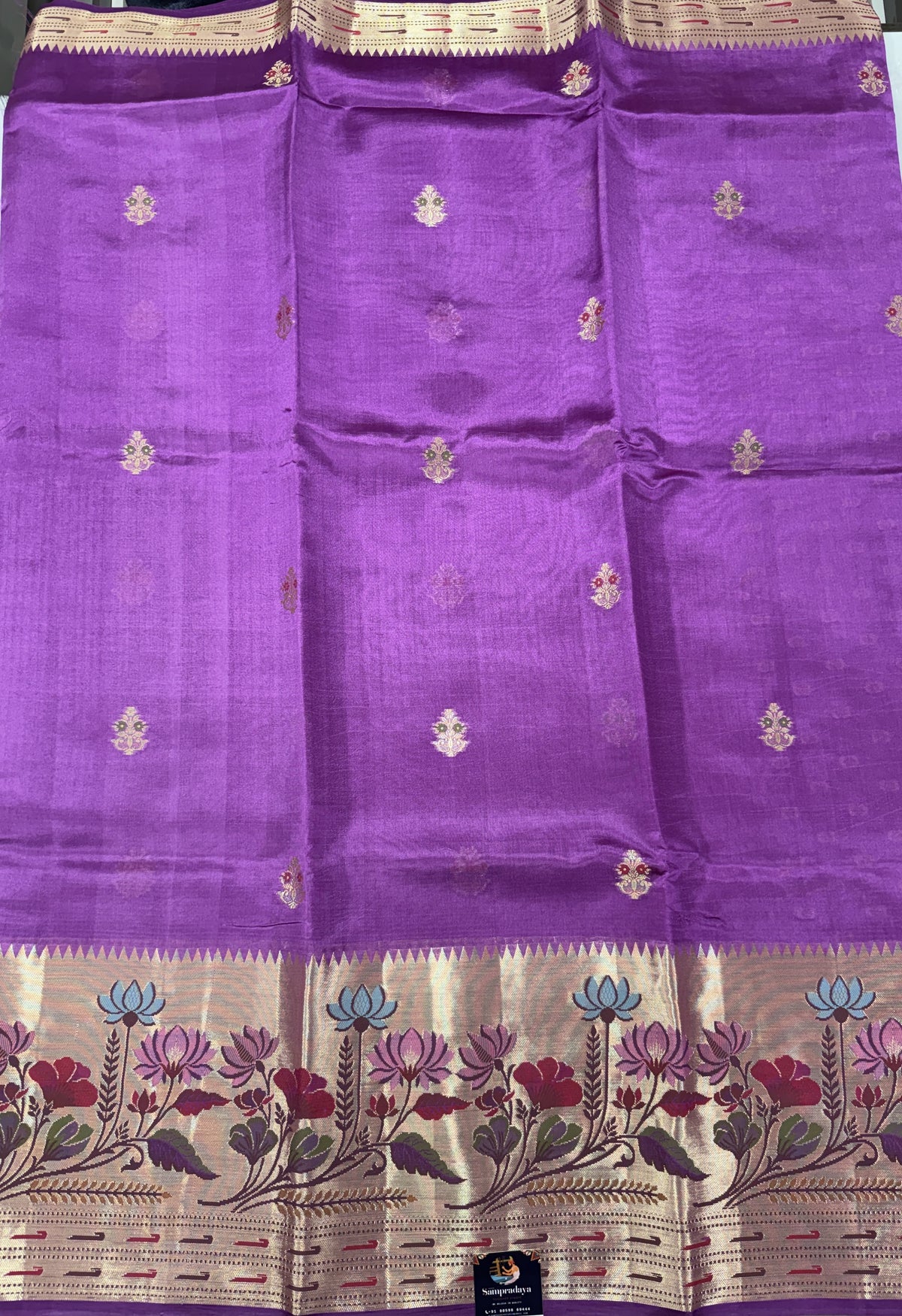 Pure Chiniya Silk Saree Striking Purple Colored Elegantly Paired with a Gold Zari Border.