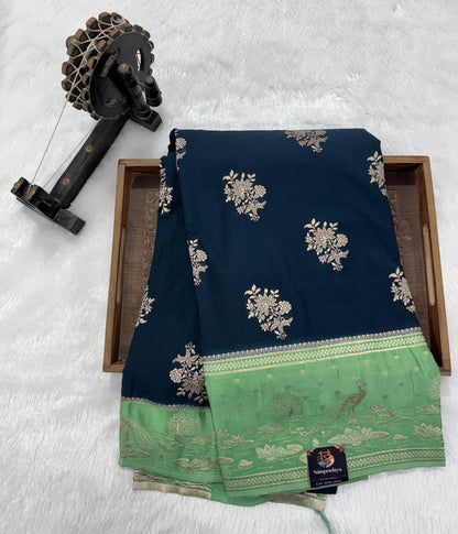Banarasi Fancy Saree Dark Teal Blue Blue Colored Complemented with a Light Green Zari Border.