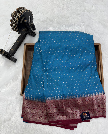 Banarasi Fancy Saree Teal Blue Colored Complemented with a Magenta Zari Border.